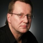 Close-up portrait of a serious businessman in eyeglasses against a dark background. of barber shop